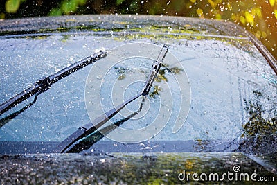 Car windshield with rain drops and frameless wiper blade Stock Photo