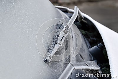 Car wiper and front window covered with frost. Wiper frozen. Stock Photo
