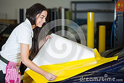 Car wrapper preparing foil to wrap a vehicle Stock Photo