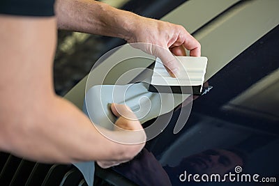 Car wrapper straightening foil with a squeegee Stock Photo