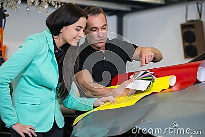 Car wrapping specialist consulting client about vinyl films Stock Photo
