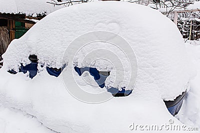 A Car in the yard with a large snowdrift Stock Photo