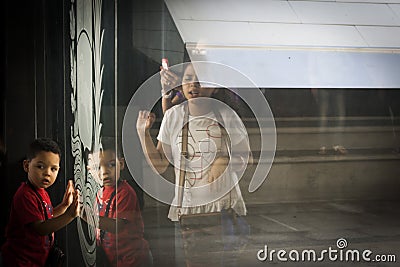 Caracas, Venezuela. Shadows and reflexes of girls and little boy on glass inside National Pantheon Editorial Stock Photo