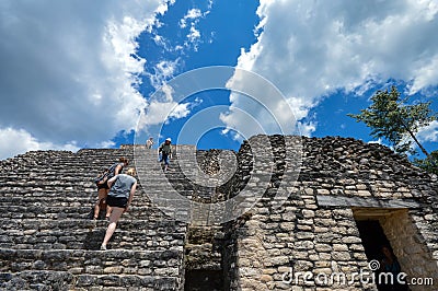 Tourists climb the stairs of Caana pyramid at Caracol archaeological site of Maya civilization, Western Belize Editorial Stock Photo