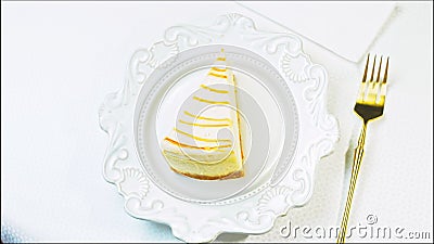 Caramel cheesecake on a retro plate. Use a gold fork and knife. Slider and macro Stock Photo