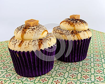 Caramel cupcakes on floral print Stock Photo