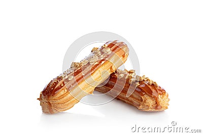 Caramel eclairs sprinkled with gold isolated on white Stock Photo