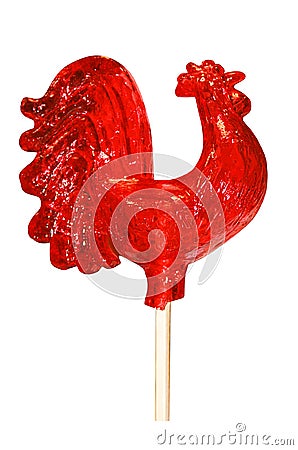 Caramel lollipop bright red very large sugar cockerel on a white background, a traditional children`s treat Stock Photo