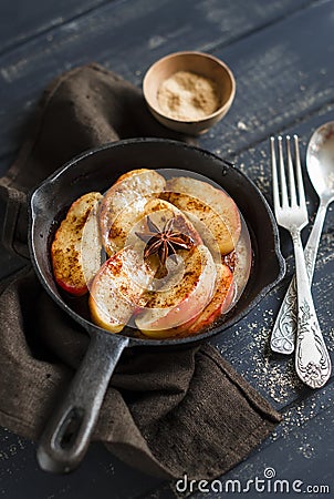 Caramelized apples with cinnamon in a vintage pan Stock Photo