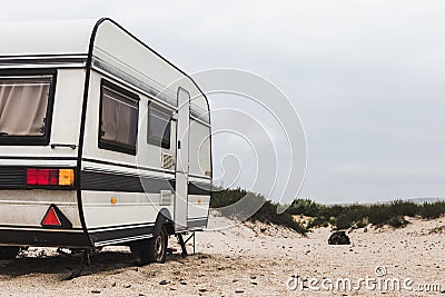 Caravan Camping Trailer On The Beach. Resting Tourism Vacation Concept Stock Photo