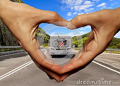 Caravan car on the road love travellng hands fingers like heart a love background Stock Photo