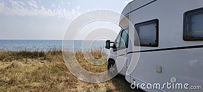 Caravan car by the sea in summer beach trees blue sky Stock Photo