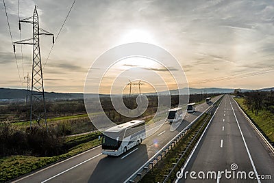 Caravan or convoy of busses on highway Stock Photo