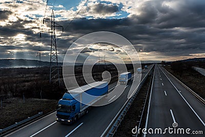 Caravan or convoy of lorry trucks on country highway Stock Photo