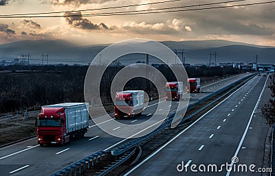 Caravan or convoy of lorry trucks on country highway Stock Photo