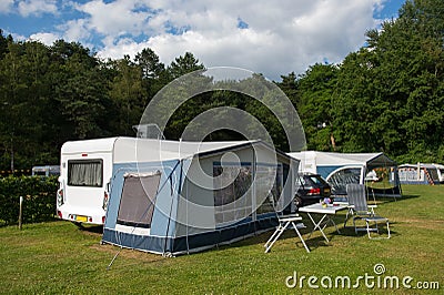 Caravan and shelter at the camping Stock Photo