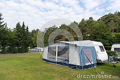 Caravan and shelter at the camping Stock Photo