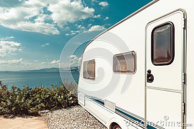 Caravan Trailer Near Sea, Beach And Blue Sky. Summer Holidays Road Trip Travel Concept Stock Photo