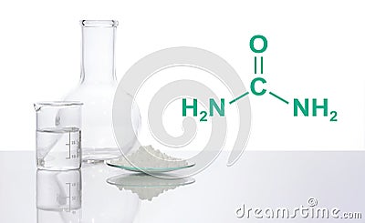 Carbamide in chemical watch Glass place next to crystal clear liquid in beaker and flat bottom flask, with the complex laitmotif Stock Photo