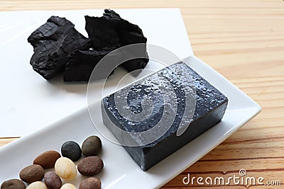 Carbon and bamboo charcoal soap on wood background Stock Photo