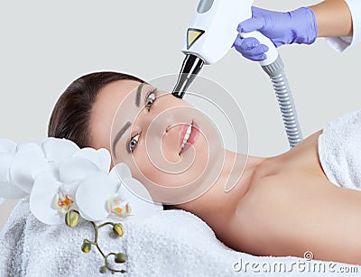 Carbon face peeling procedure in a beauty salon. Stock Photo