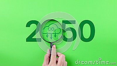 Carbon reduce emission concept, Hand holding Magnifying glass with CO2 reduction in 2050 year, Kyoto Protocol to carbon neutrality Stock Photo