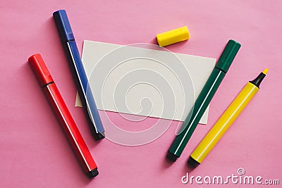 Card with copy space and colored markers on a pink background Stock Photo