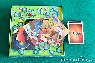 Card deck and pictures on box of Dixit board game Editorial Stock Photo