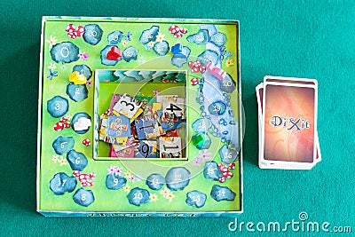 Card deck, tiles and box of Dixit board game Editorial Stock Photo