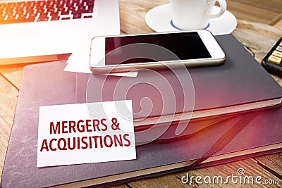 Card with Mergers & Acquisitions text on office desktop Stock Photo