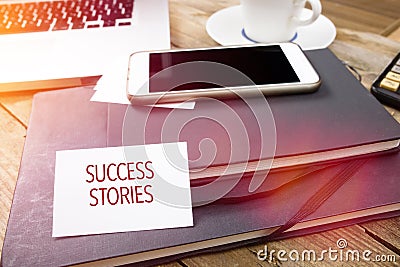 Card saying Success Stories on note pad Stock Photo