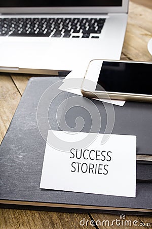 Card saying Success Stories on note pad Stock Photo