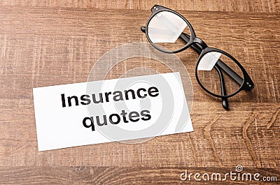 Card with text INSURANCE QUOTES Stock Photo
