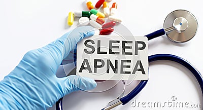 Card with text SLEEP APNEA supplies, pills and stethoscope. Medical concept Stock Photo