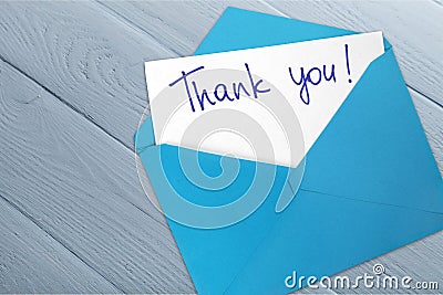 Thank you card and envelope on wooden background Stock Photo