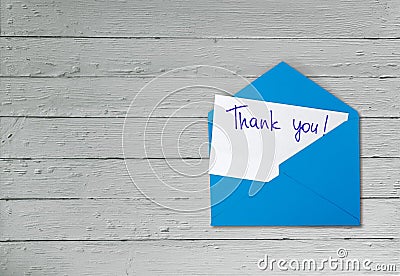 Thank you card and envelope on wooden background Stock Photo