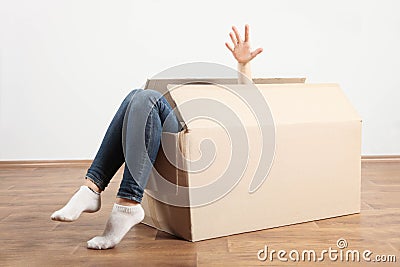 Cardboard box with female legs Stock Photo