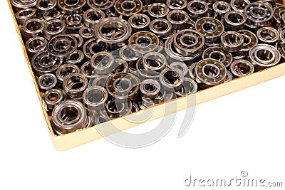 Cardboard box with many small ball bearings isolated on white ba Stock Photo