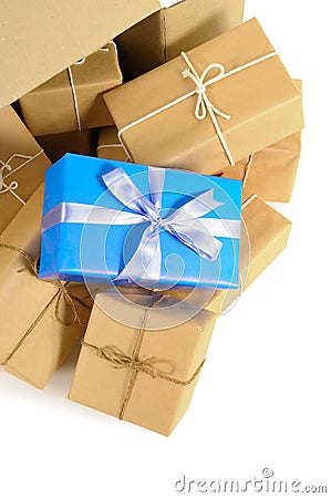 Cardboard box with several brown paper parcels and single unique christmas or birthday gift Stock Photo