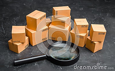 Cardboard boxes and glass on a dark background. The concept of packing goods, sending orders to customers. Warehouse of finished Stock Photo