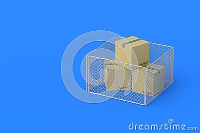 Cardboard boxes and metal grid fence Stock Photo