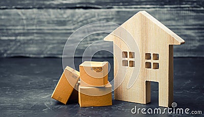 cardboard boxes near the house. The concept of moving to another house, relocation. Transportation of property and goods Stock Photo