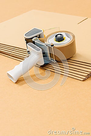 Cardboard Boxes and Tape Gun Stock Photo