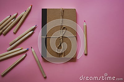 Cardboard notepad for notes tied with sacking rope bow flatly Wooden pink pencil Stock Photo