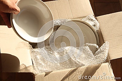 Cardboard Packing Box, Plates and Bubble Wrap Stock Photo