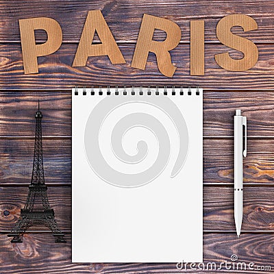 Cardboard Paris Sign with Eiffel Tower, Pen and Blank Notebook w Stock Photo