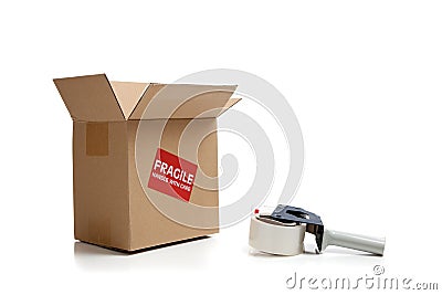 Cardboard shipping box with a tape gun Stock Photo