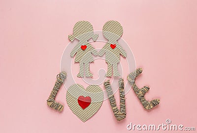 Cardboard silhouettes girl and boy with hearts and the word love Stock Photo