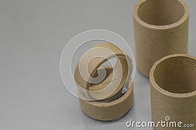 Cardboard spools for winding. Reels made of cardboard. Background of cardboard bobbins. Selective focus Stock Photo