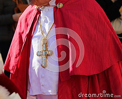 cardinal wearing a cassock with the big cross inlaid with precious gems during the ceremony Stock Photo